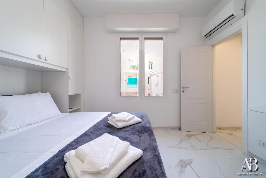 A bed or beds in a room at [Suite Aurora] Luxury in the center of Sanremo