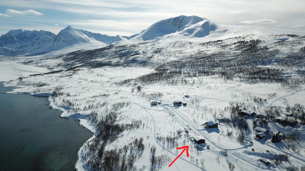 an aerial view of a mountain with snow and water at Storgalten gjestehus in Nord-Lenangen