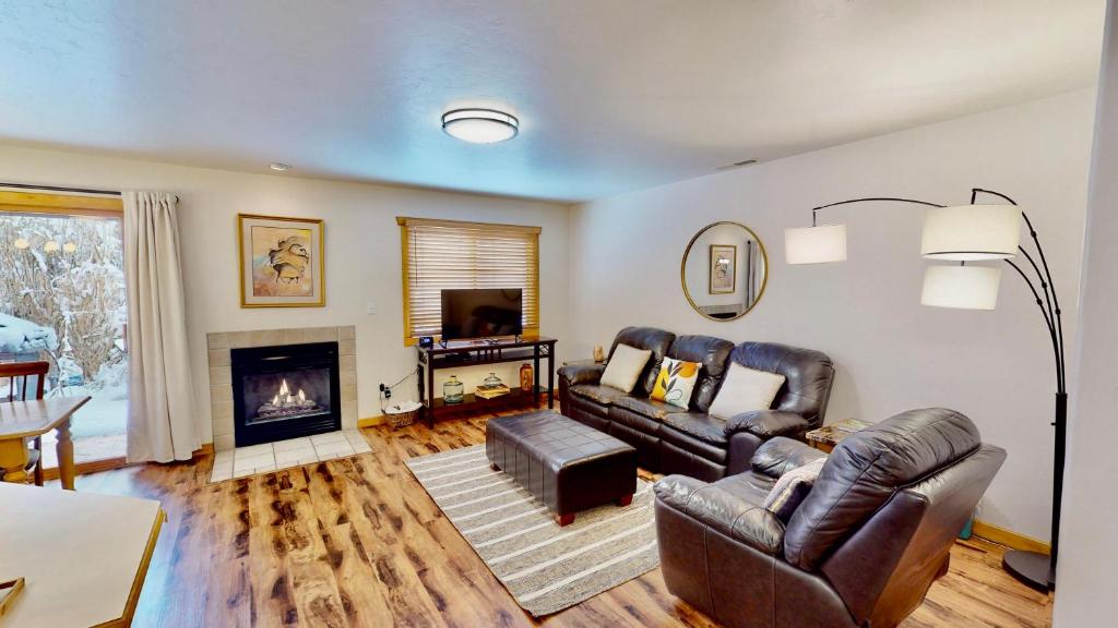 a living room with two leather couches and a fireplace at The Rock #3461 in Moab