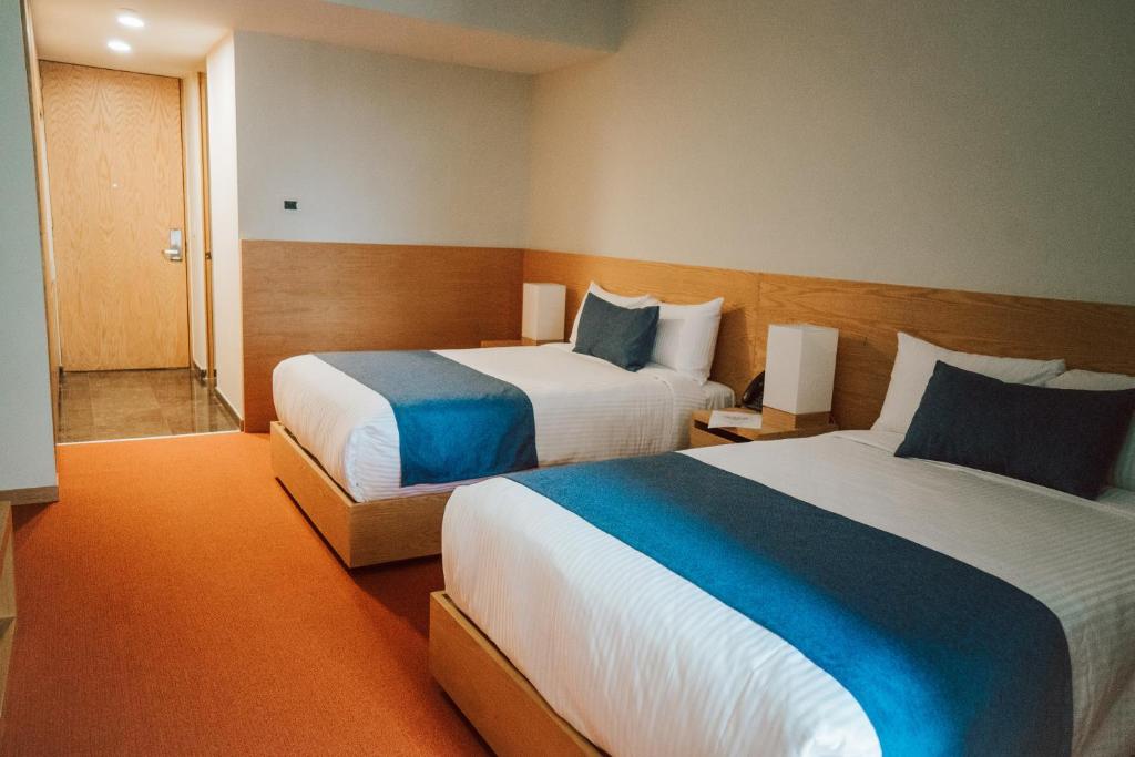 Postel nebo postele na pokoji v ubytování Gran Hotel Concordia