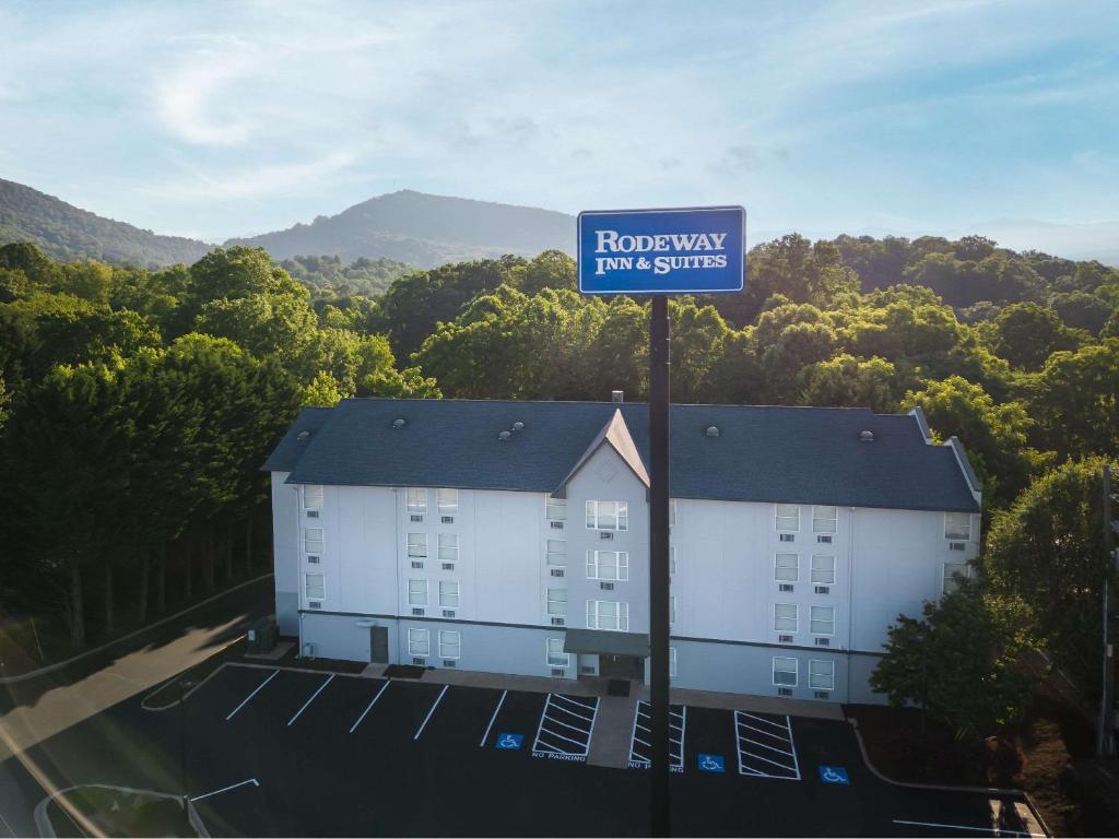 a building with a sign that reads renovated for suites at Rodeway Inn & Suites near Outlet Mall - Asheville in Asheville