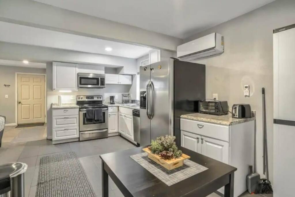 a kitchen with stainless steel appliances and a table at 2 bedroom* Minutes from downtown *Firepit in Colorado Springs