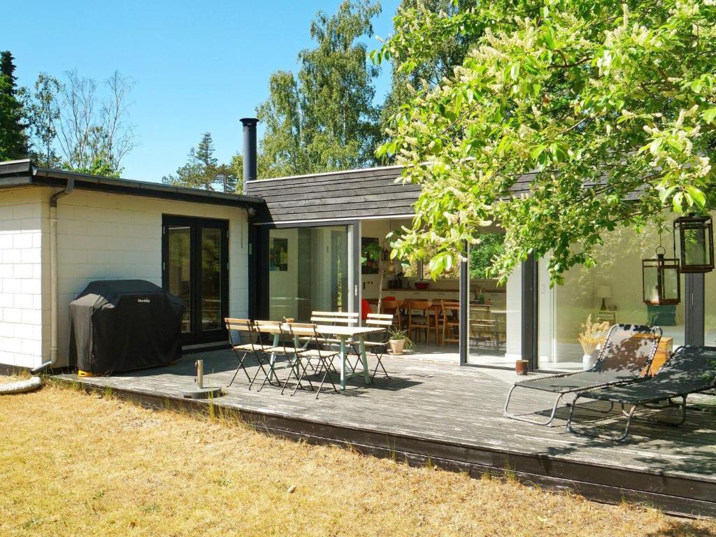 a house with a patio with a table and chairs at Charming Retreat by Water - By Traum Ferienwohnungen in Nykøbing Sjælland