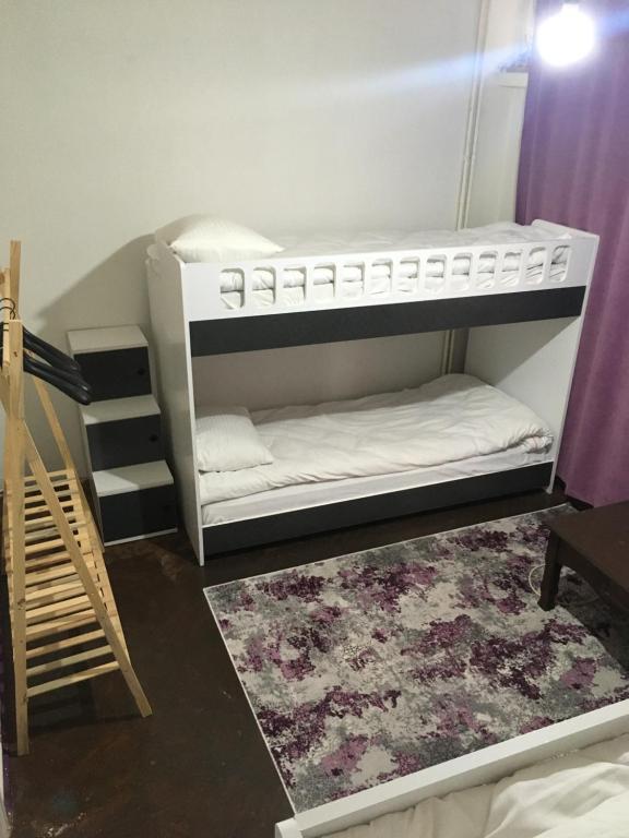 a room with two bunk beds and a rug at Hostel Taksim in Istanbul