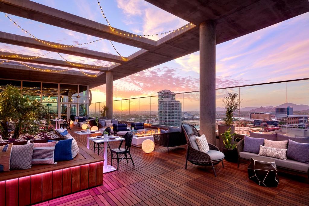 a rooftop patio with furniture and a view of the city at Omni Tempe Hotel at ASU in Tempe
