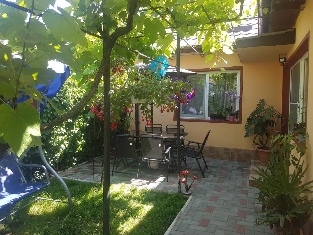 a patio with a table and chairs in a yard at Lovely Apartment With Courtyard in Mangalia