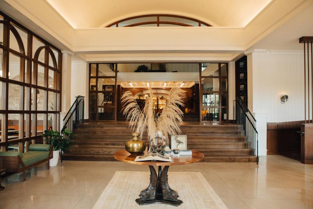 a lobby with a table in the middle of a building at Hotel Emeline in Charleston