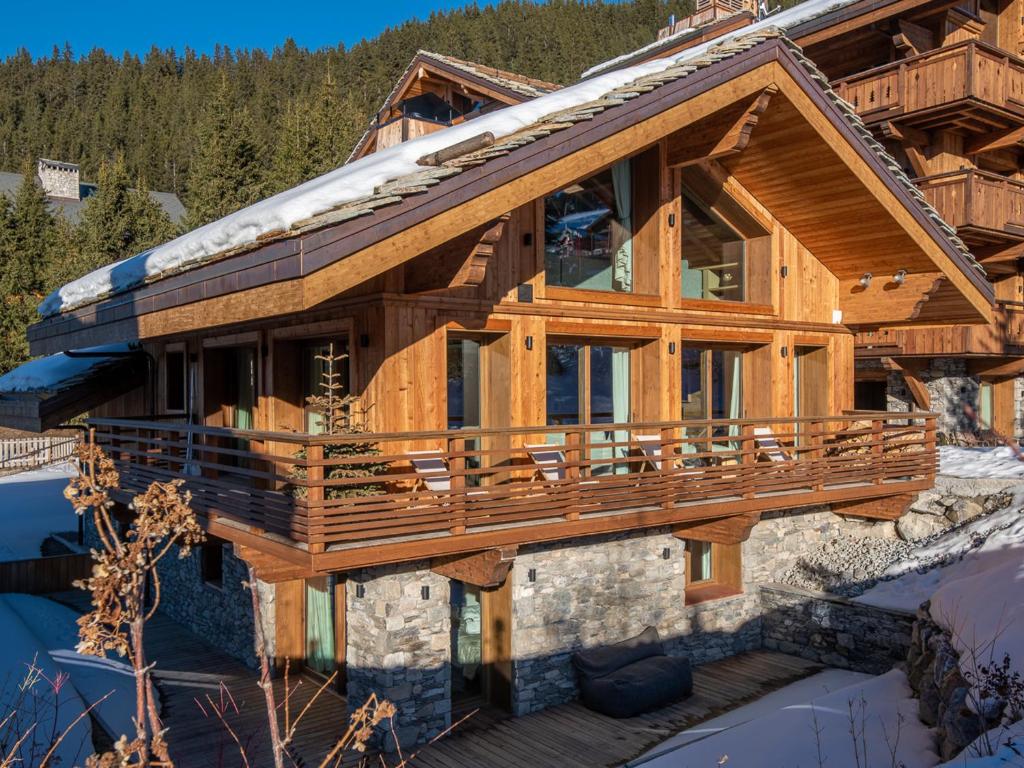 a log home with a wrap around deck in the snow at Chalet Méribel, 8 pièces, 13 personnes - FR-1-613-52 in Méribel