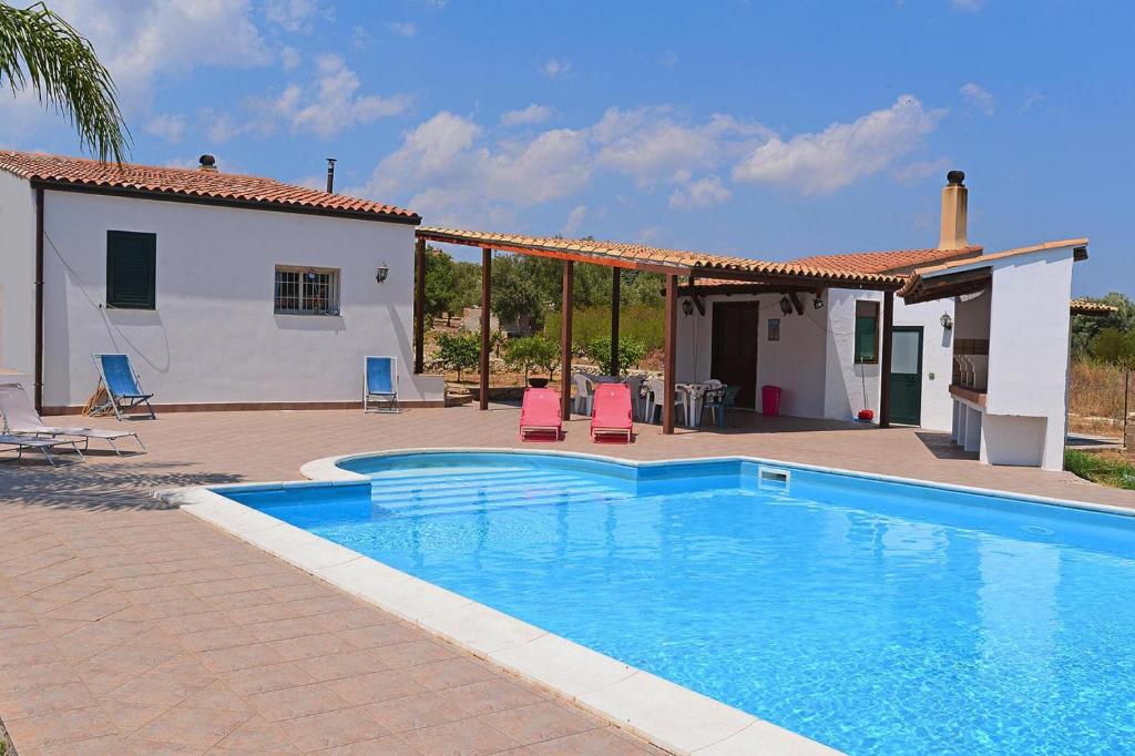a swimming pool in front of a house at Holiday Home Floridia - ISI02274-F in Floridia