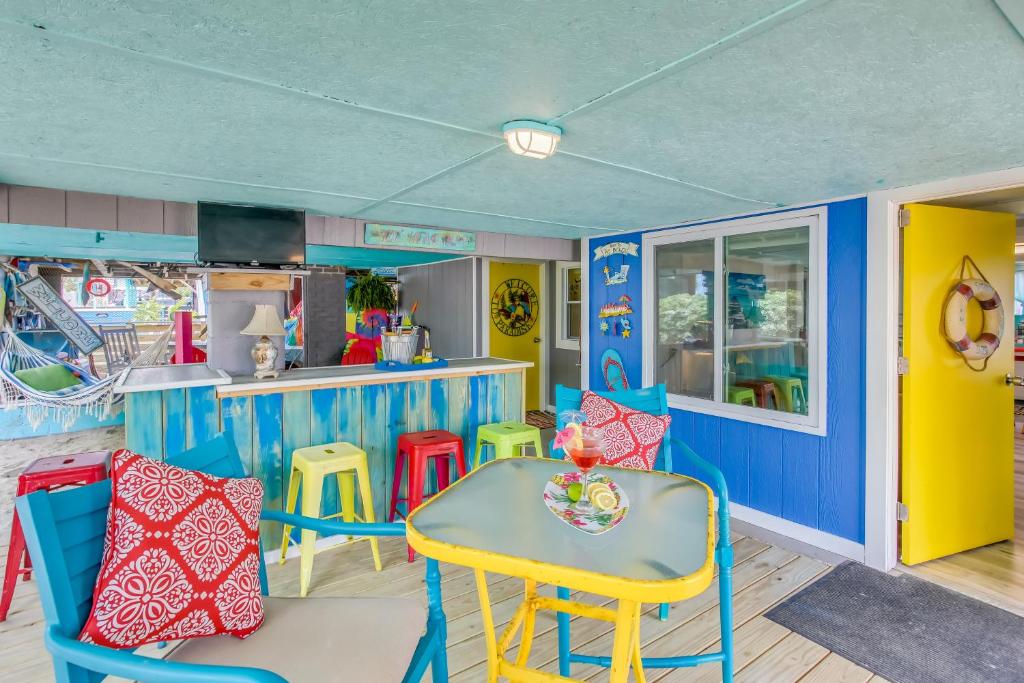 a dining room with a table and chairs at Colorful Murrells Inlet Gem with Outdoor Space! in Myrtle Beach