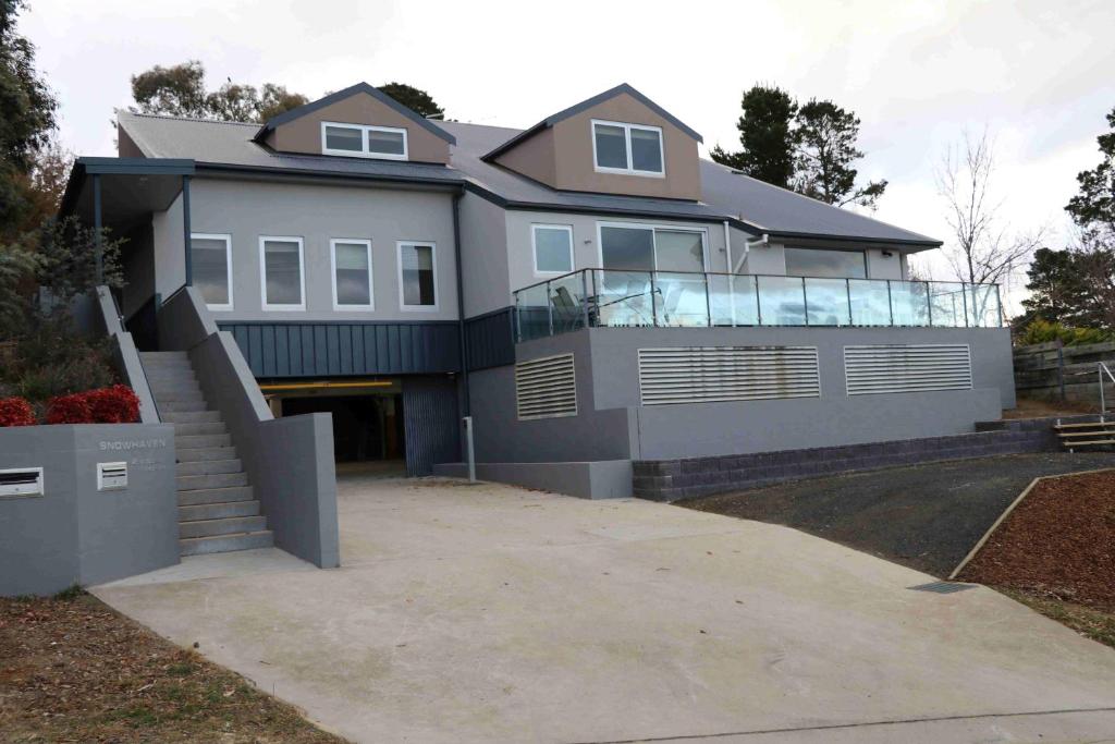 a large house with a balcony on top of it at Snowhaven in Jindabyne