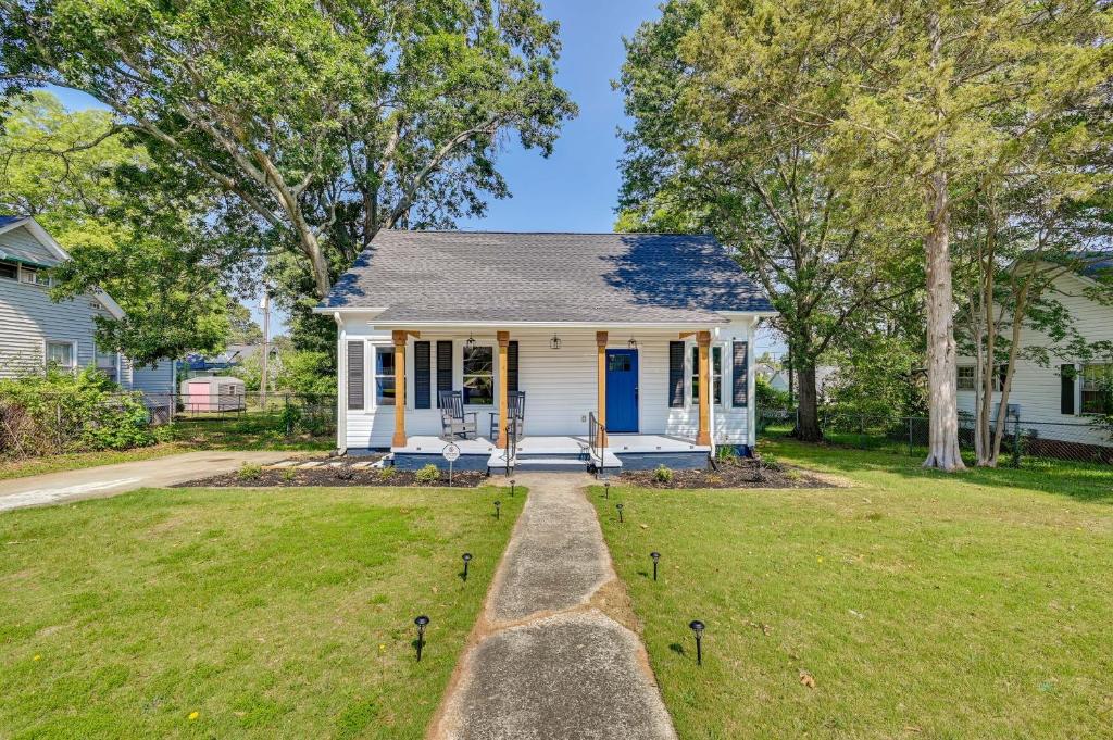 a white house with a blue door and a yard at Updated Greenville Home with Backyard! in Greenville