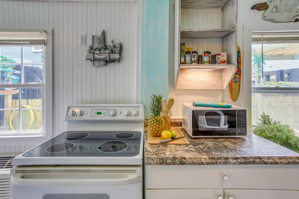 a kitchen with a stove and a microwave on a counter at Murrells Inlet Apartment with Direct Beach Access! in Myrtle Beach