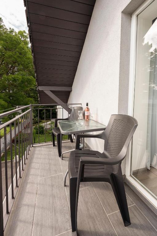 A balcony or terrace at Kikötő Apartmanok