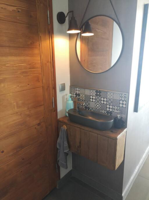 a bathroom with a sink and a mirror at Villa 10 p.Brando 170 m2 vue mer panoramique in Brando