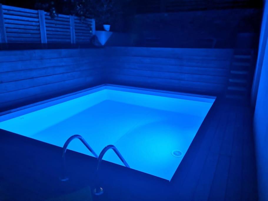 a swimming pool with a blue light in it at Villa 10 p.Brando 170 m2 vue mer panoramique in Brando