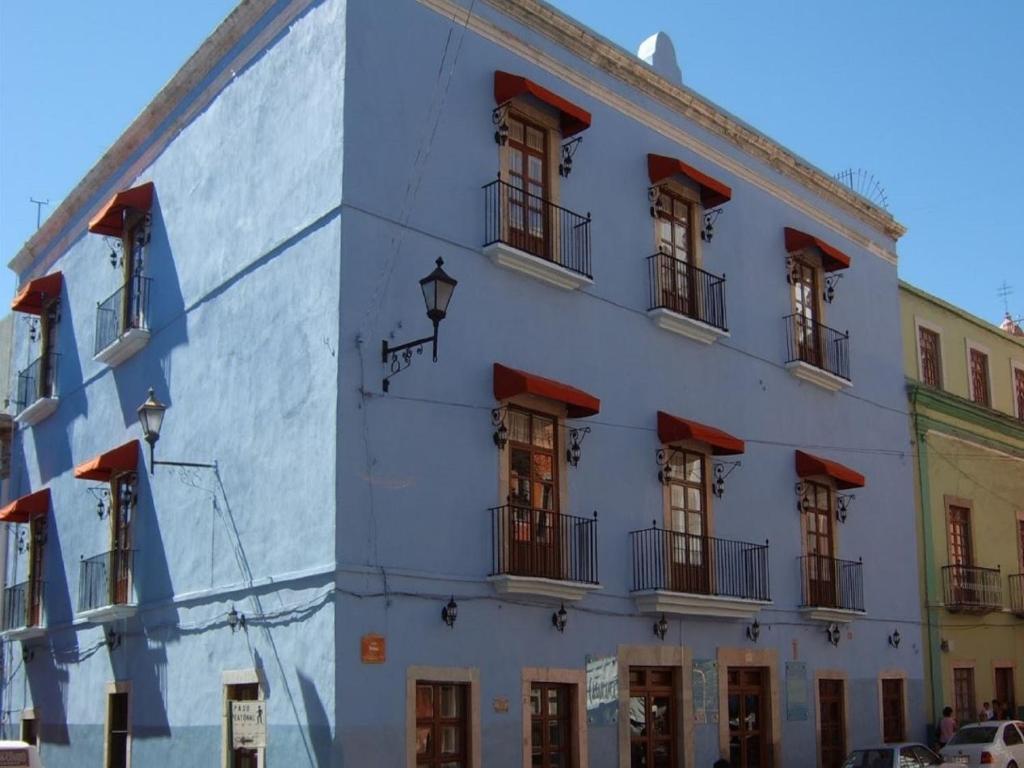 a large white building with windows and balconies at Casa del Agua in Guanajuato