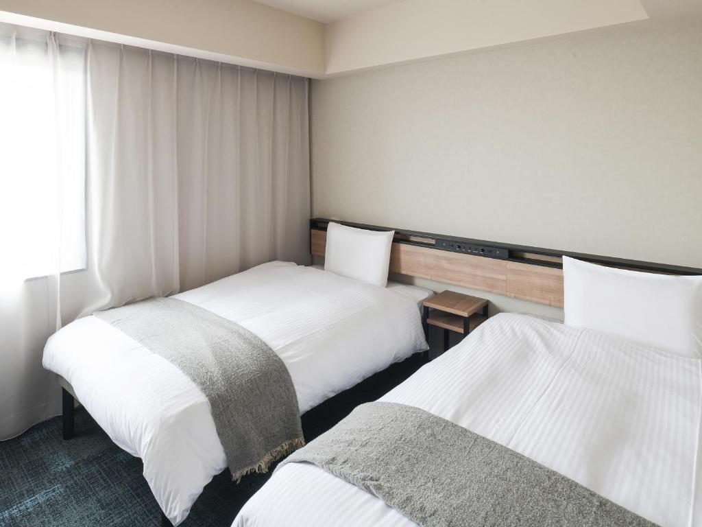 Postel nebo postele na pokoji v ubytování REF Kansai Airport by VESSEL HOTELS