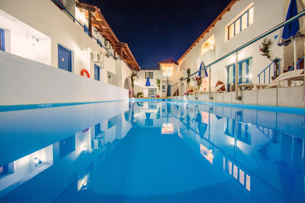 a swimming pool in a house at night at Iliana Hotel in Panormos Rethymno