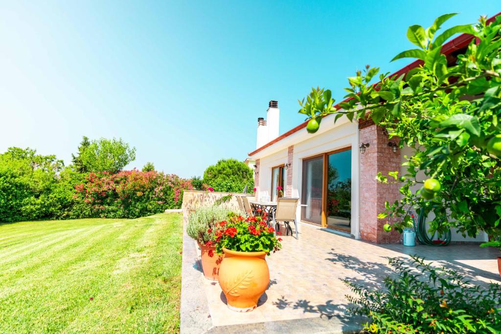 a house with a large vase of flowers on a patio at Villa Bougainvillea in Epanomi