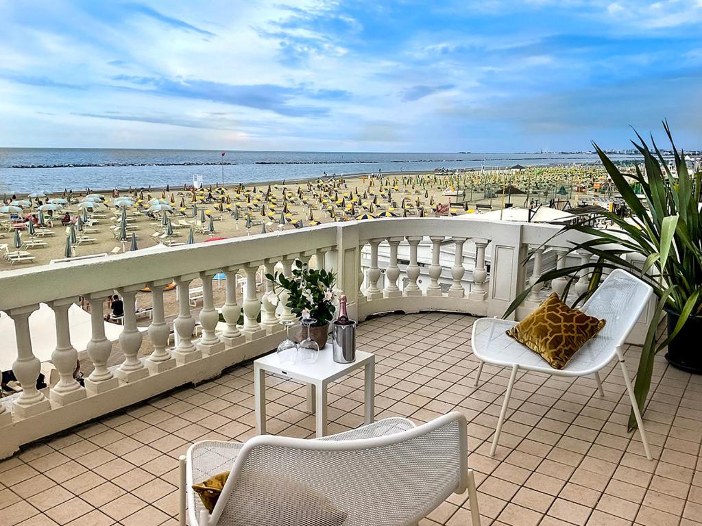 a balcony with a view of a beach with people at Villa La Torretta Luxury B&B - Adults Only - in Rimini