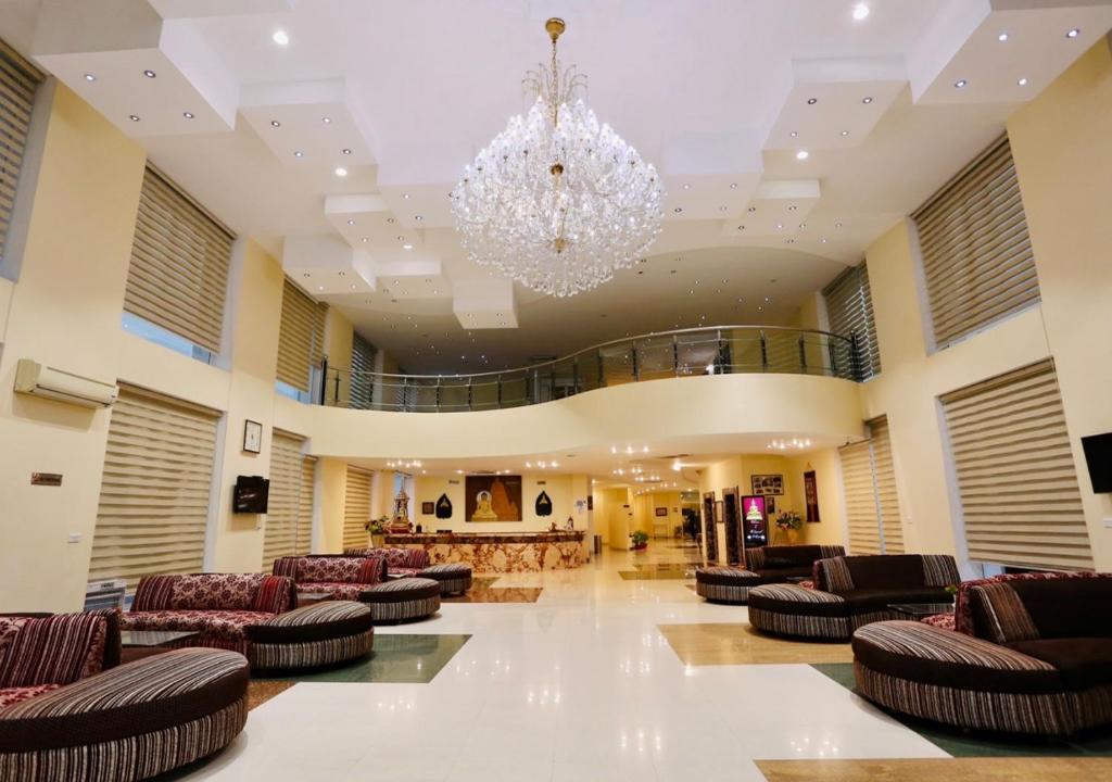a large lobby with couches and a chandelier at The Imperial Bodhgaya in Bodh Gaya