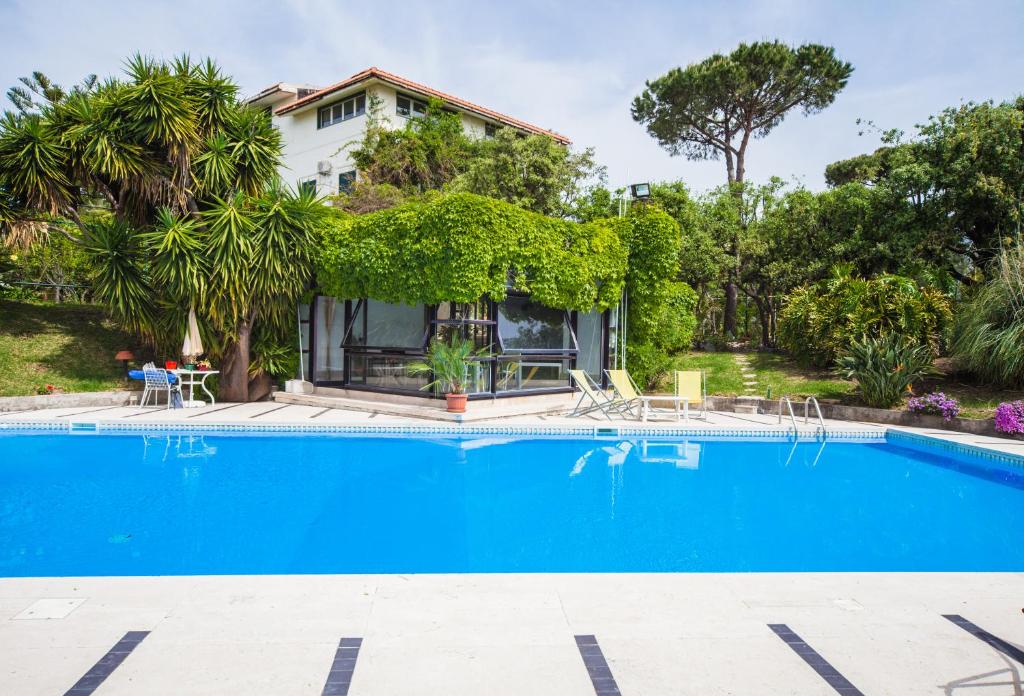 a swimming pool in front of a house at B&B Casina de Goyzueta in Torre del Greco