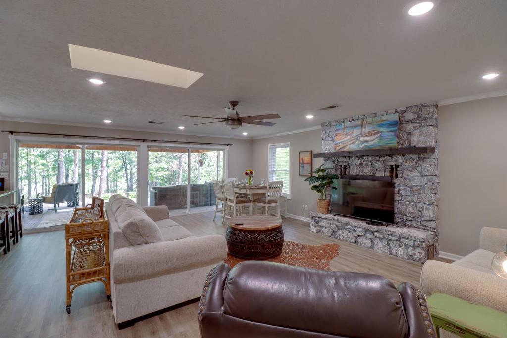 a living room with a couch and a fireplace at Arkansas Vacation Rental on Greers Ferry Lake! in Fairfield Bay
