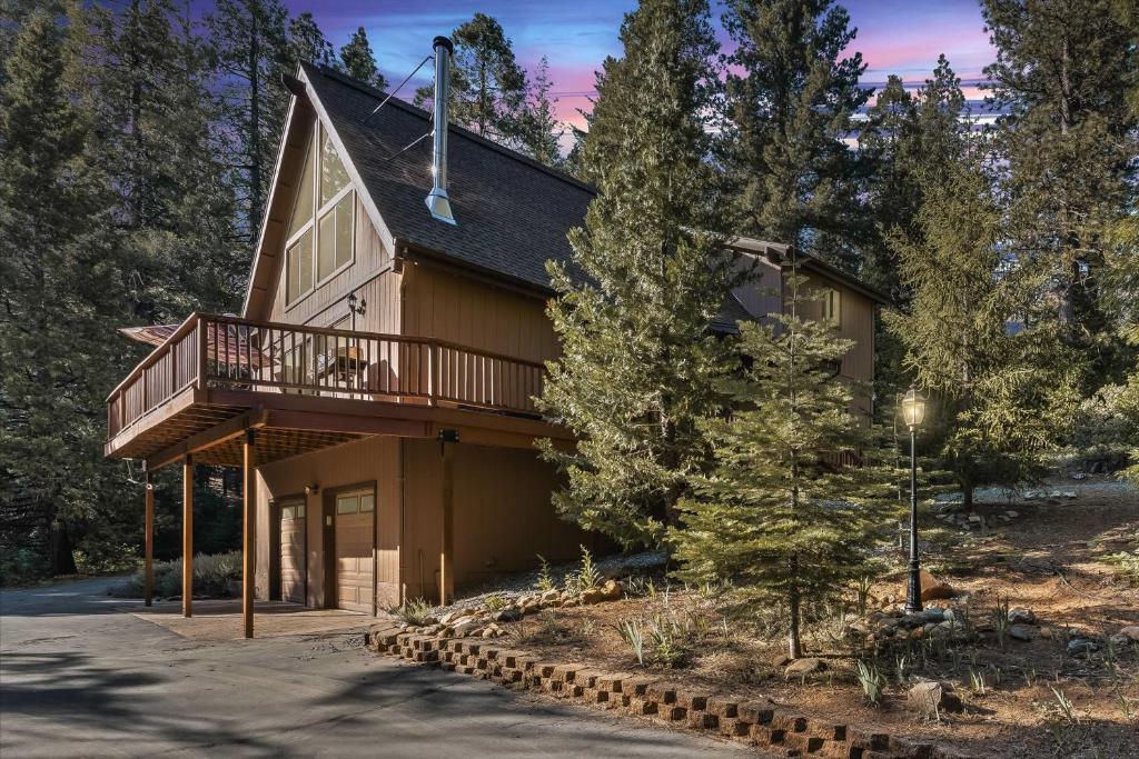 a house with a balcony on the side of it at Charming Cabin Near Kirkwood Ski Resort with Hot Tub in Pioneer