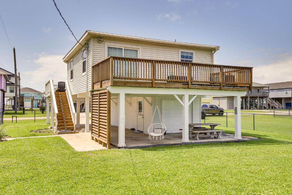 a house with a deck and a swing at Walk to Beach Updated Home with Deck in Galveston! in Galveston