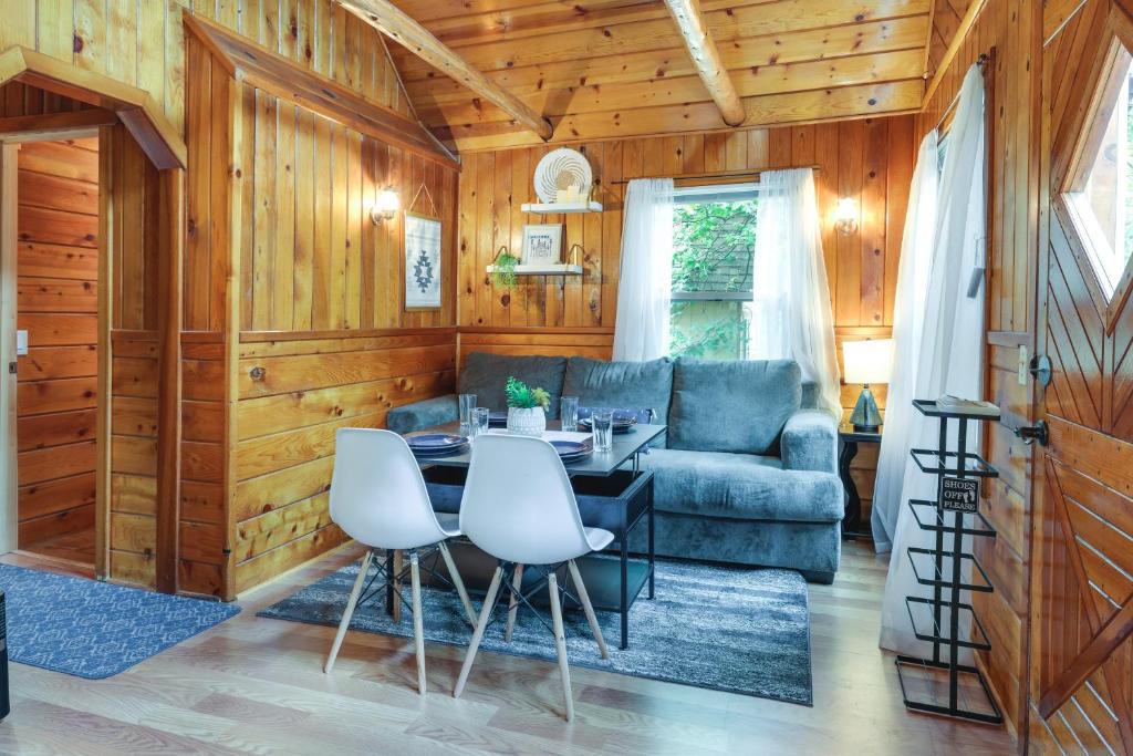 a living room with a table and a couch at Twain Harte Cabin with Deck and Fire Pit! in Twain Harte