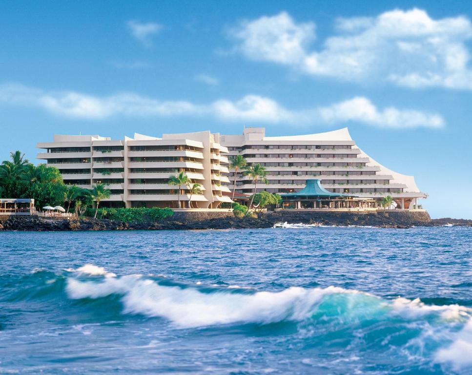 ein großes Hotel am Ufer eines Wasserkörpers in der Unterkunft Royal Kona Resort in Kailua-Kona