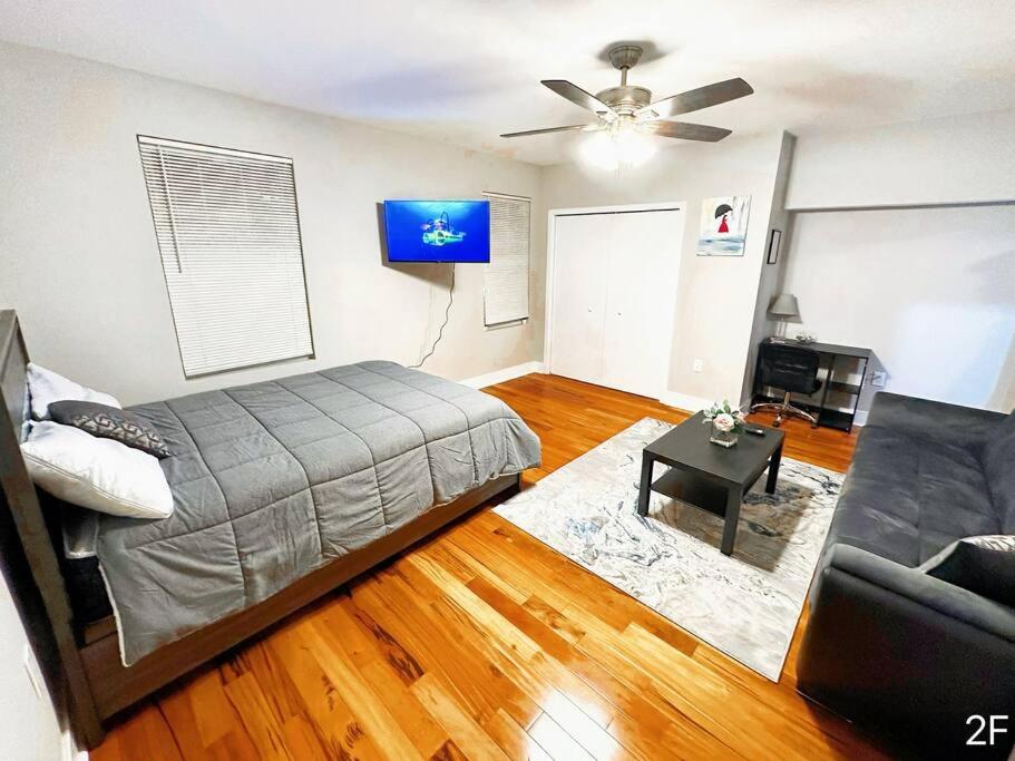 a bedroom with a bed and a couch and a table at Renovated Private 1B/1B w/ Kitchen in Philadelphia