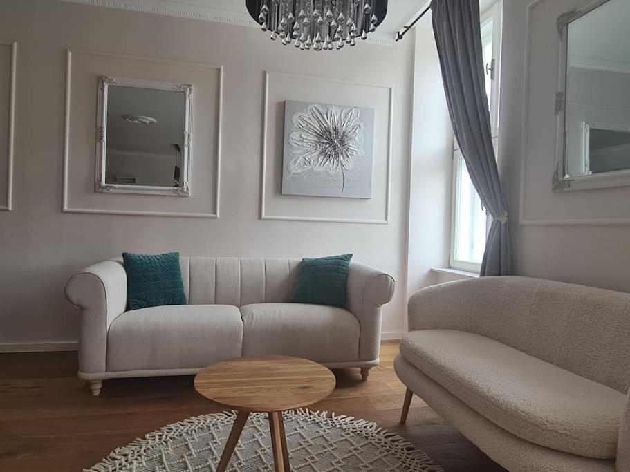 a living room with a couch and a table at Elegant bourgeois apartment in Kamnik