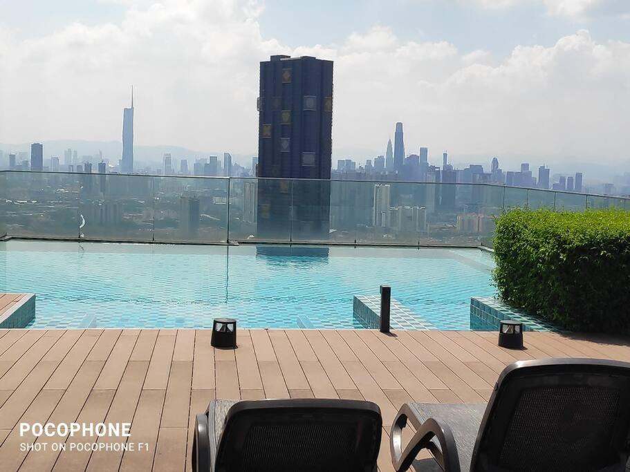 a swimming pool on top of a building with a city at EkoCheras Residences Van Gogh theme design with MRT Cheras in Kuala Lumpur