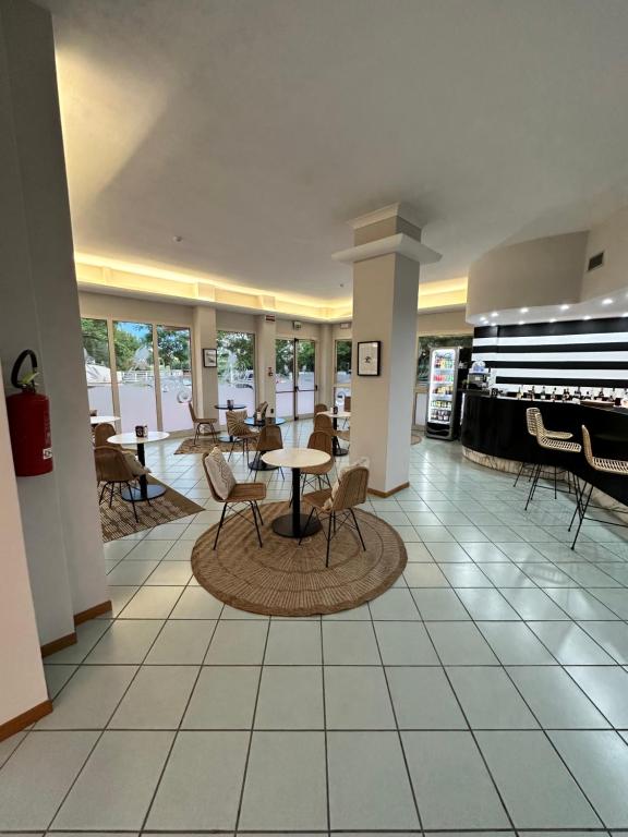 a lobby with a table and chairs in a building at Hotel St Gregory Park in Rimini