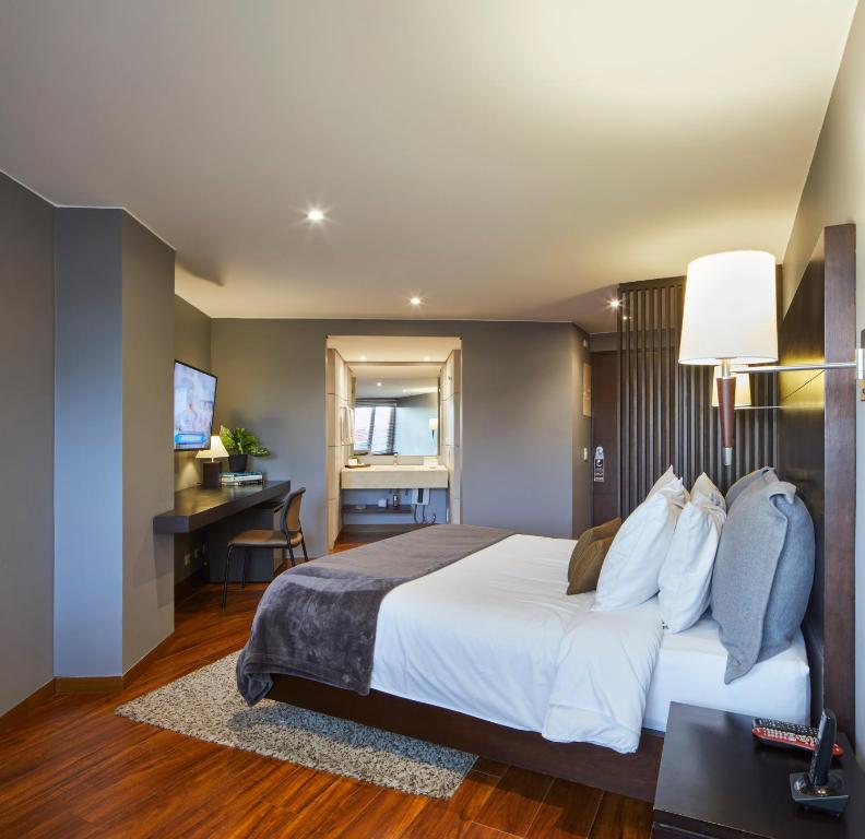 Postel nebo postele na pokoji v ubytování Nico Apartasuites