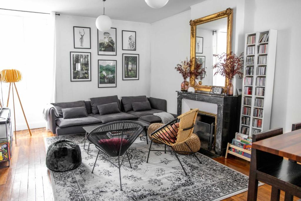 a living room with a couch and a fireplace at La Demeure de Chemonton - 6 personnes, 2 chambres in Blois