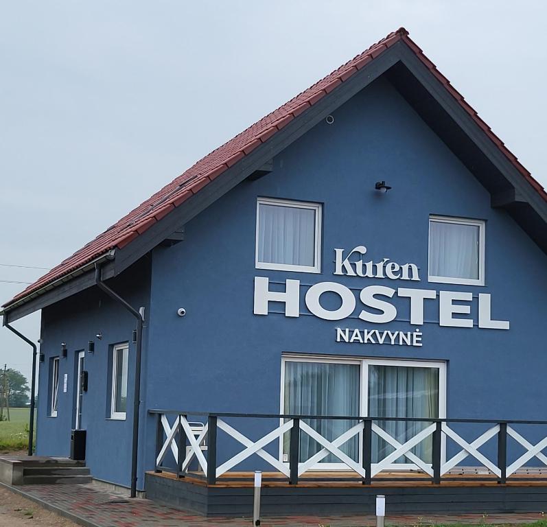 a blue building with the name of a hospital at Kuren Hostel in Karklė