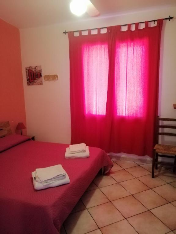 Postel nebo postele na pokoji v ubytování B&B Bella Calasetta