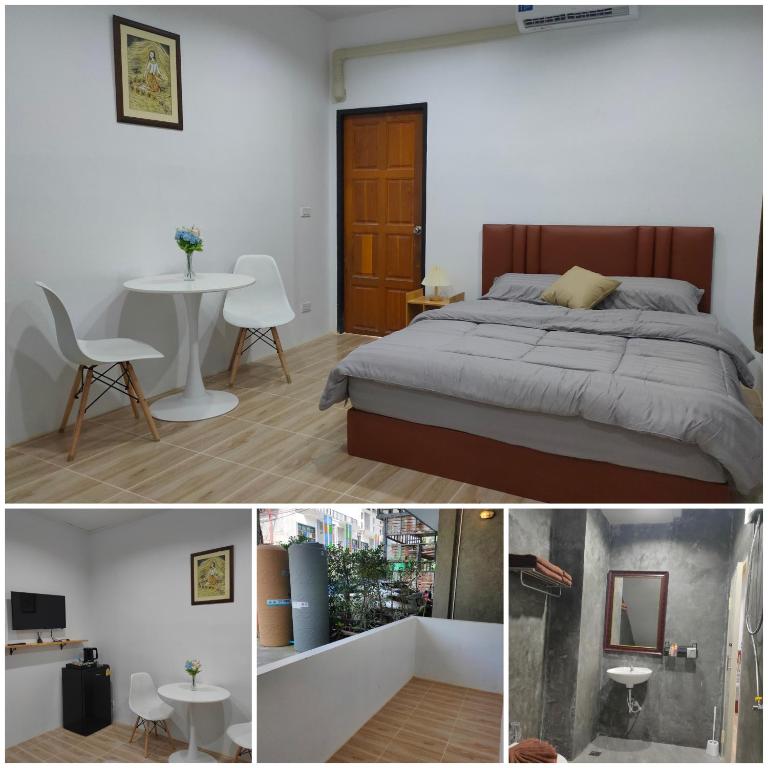 a bedroom with a bed and a table and a chair at Phudis Guest House in Ban Khlong Haeng