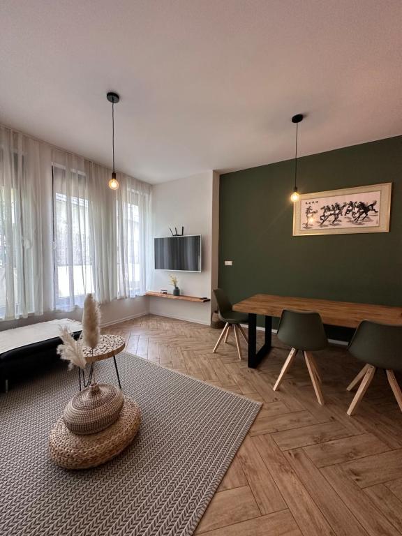 a living room with a table and chairs at Apartma Winter Garden Kranjska Gora in Kranjska Gora