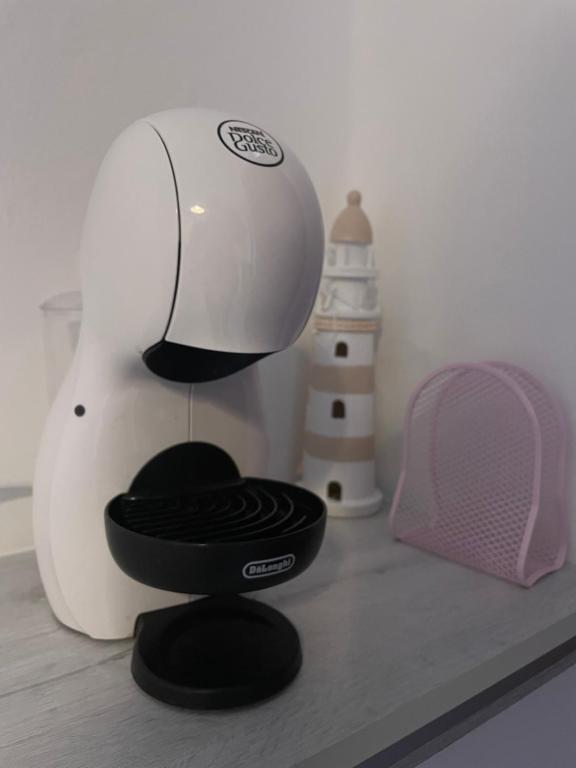 a hair dryer sitting on a counter next to a lighthouse at ACHILLE in Porto Recanati