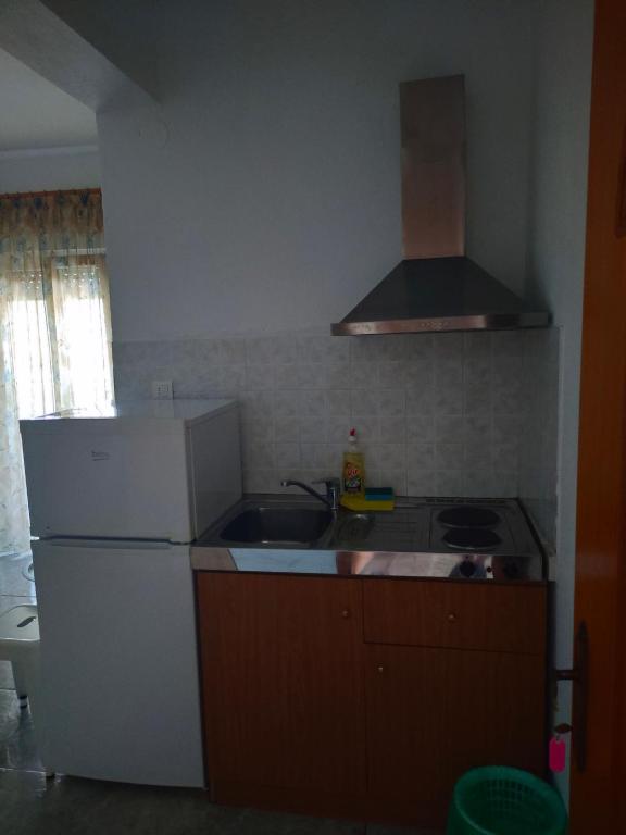 a kitchen with a white refrigerator and a sink at Vigla House in Sykia Chalkidikis