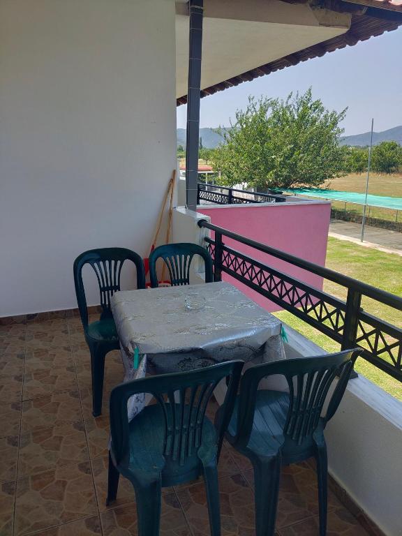 a table and four chairs on a balcony with a table at Vigla House in Sykia Chalkidikis