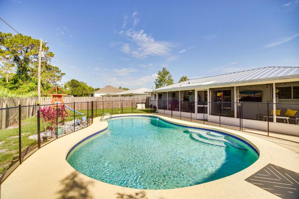 a swimming pool in the backyard of a house at Palm Bay Vacation Rental with Private Pool! in Palm Bay