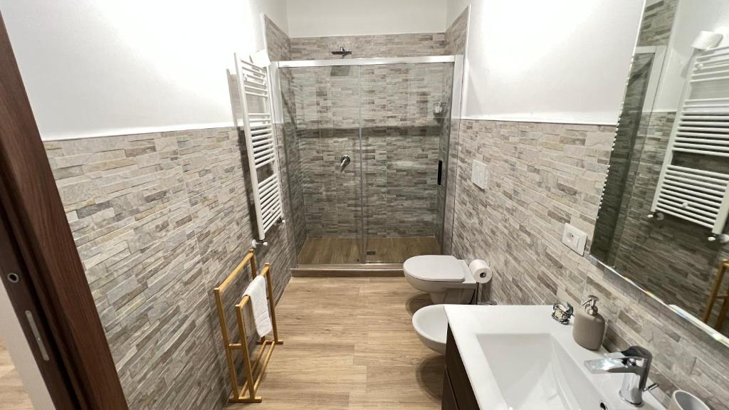 a bathroom with a shower and a toilet and a sink at Cala Portavecchia in Monopoli