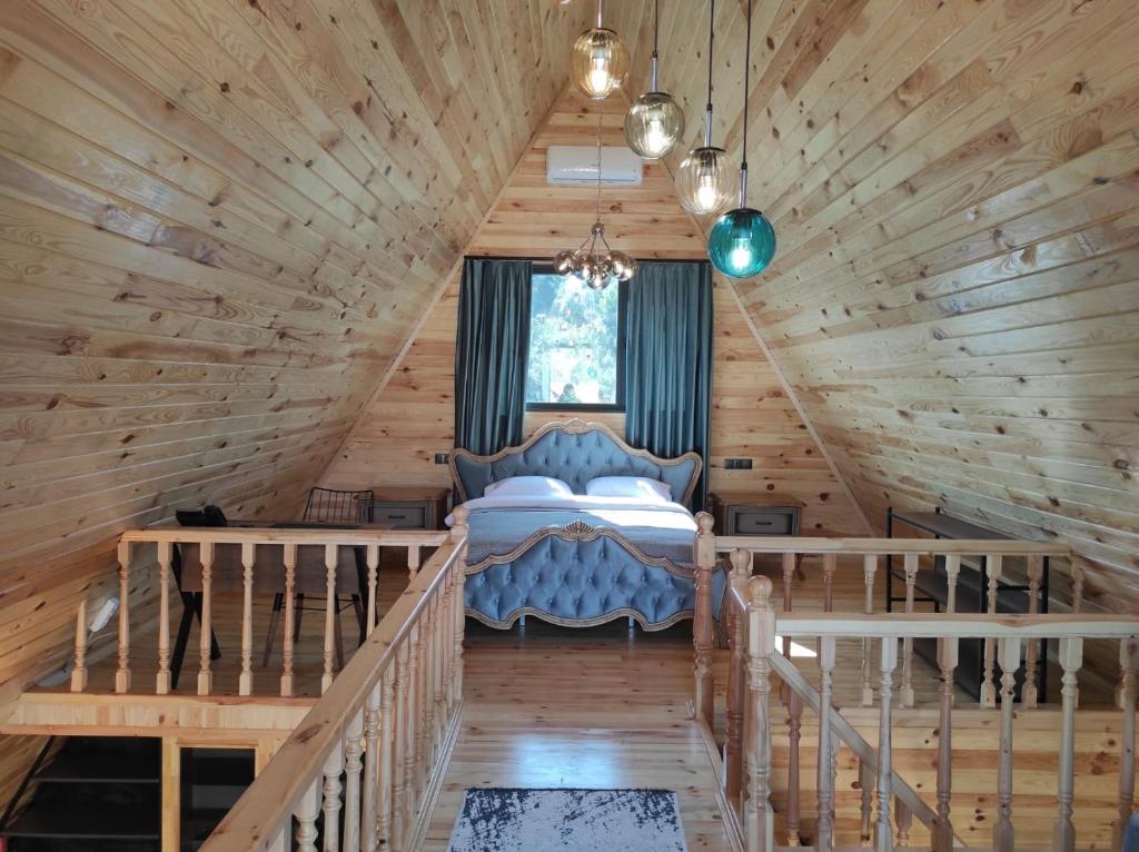 a bedroom in a log cabin with a bed in it at 7Sense Nature Resort in Sapanca