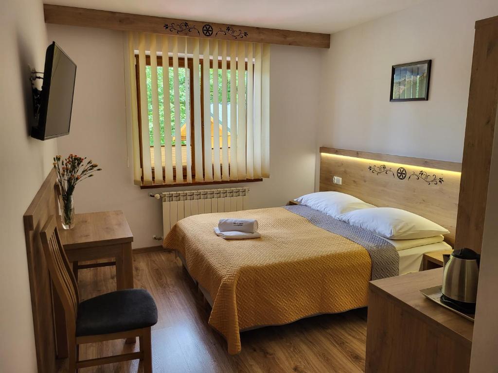 a small bedroom with two beds and a window at Willa U Zająców I in Zakopane