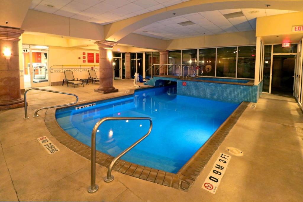 a large swimming pool in a large building at Wyndham Garden McAllen at La Plaza Mall in McAllen